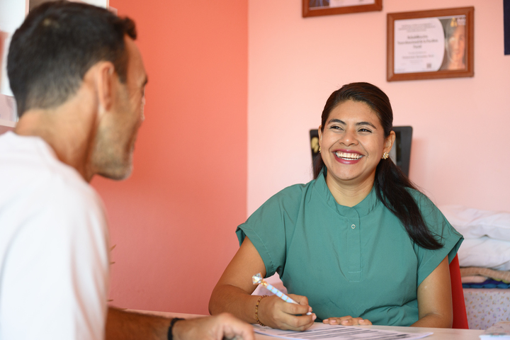 Female doctor smiling and talking with patient in medical office in Mexico healthcare in Mexico without insurance